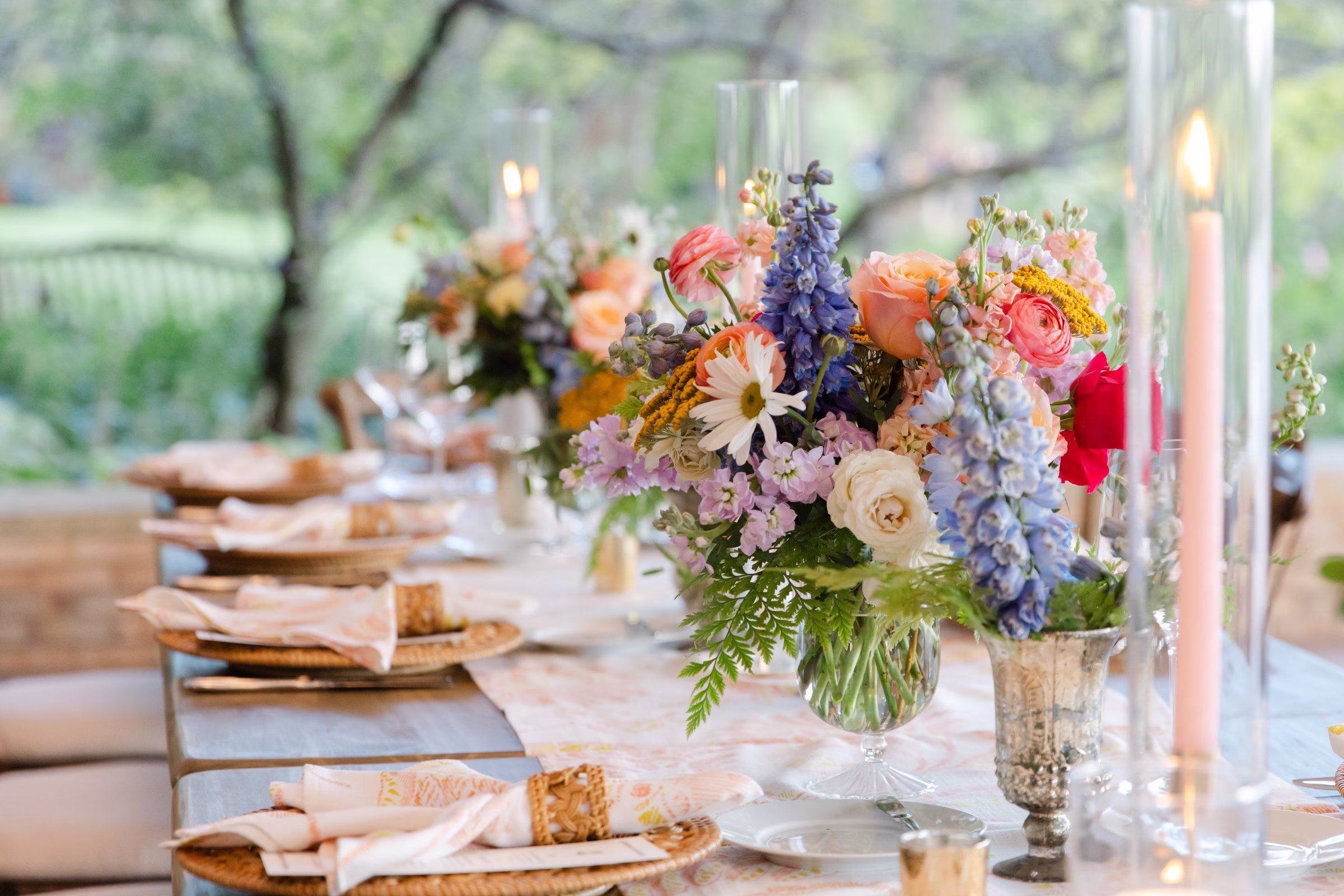 chicago rochester wedding designer erin mcdonald floral centerpiece tablescape - Destination Event Design Elegant wedding tablescape with colorful floral centerpieces featuring coral ranunculus, blue delphinium and white roses designed by Chicago and Rochester NY wedding designer Erin McDonald