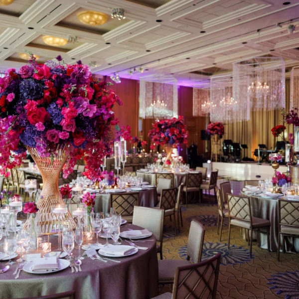 Elegant Chicago wedding reception with dramatic purple and magenta floral centerpieces designed by Erin McDonald in luxurious ballroom setting