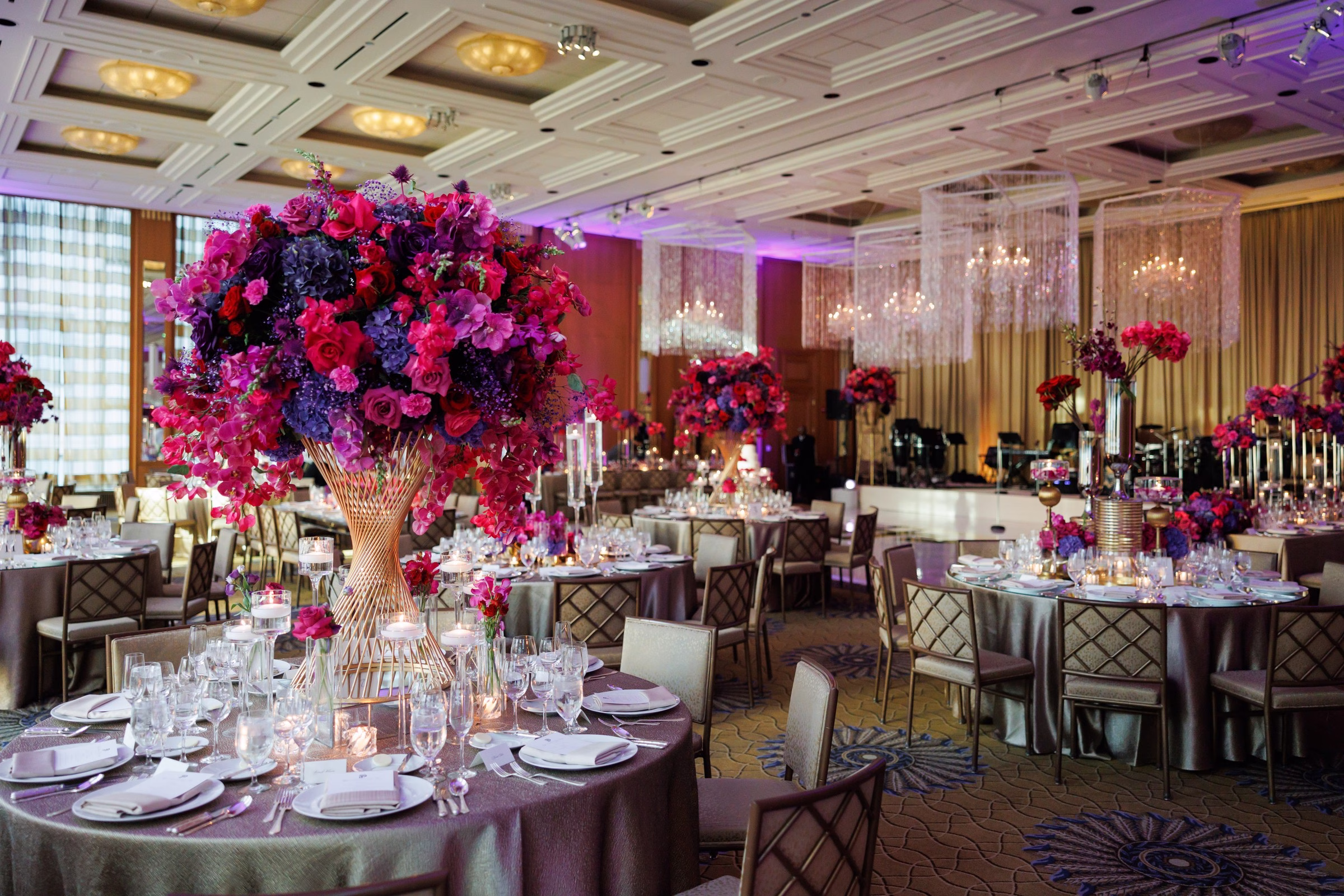 Elegant Chicago wedding reception with dramatic purple and magenta floral centerpieces designed by Erin McDonald in luxurious ballroom setting