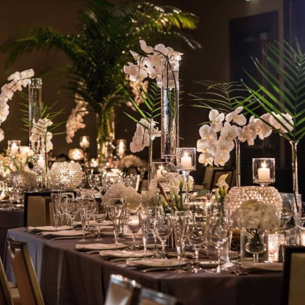 Elegant Chicago wedding reception tablescape with crystal centerpieces and white orchids designed by Erin McDonald