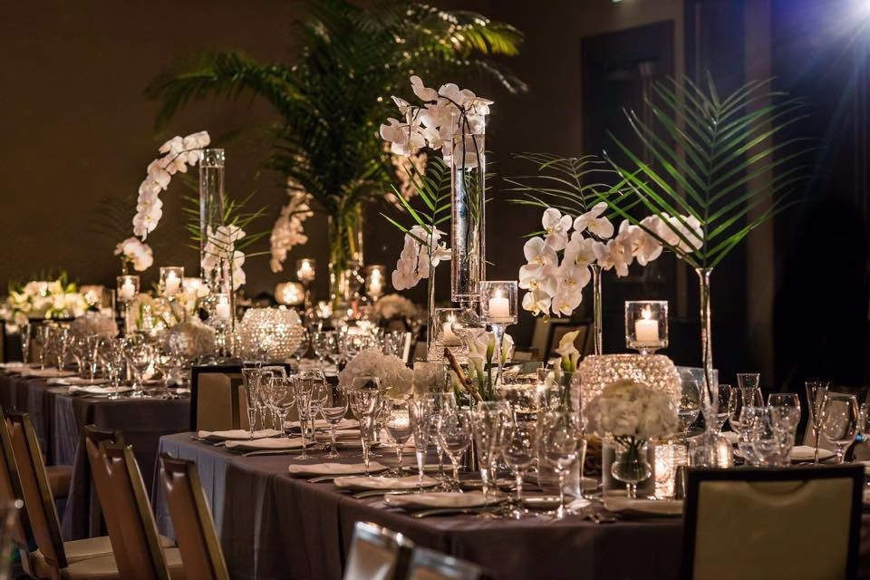 Elegant Chicago wedding reception tablescape with crystal centerpieces and white orchids designed by Erin McDonald
