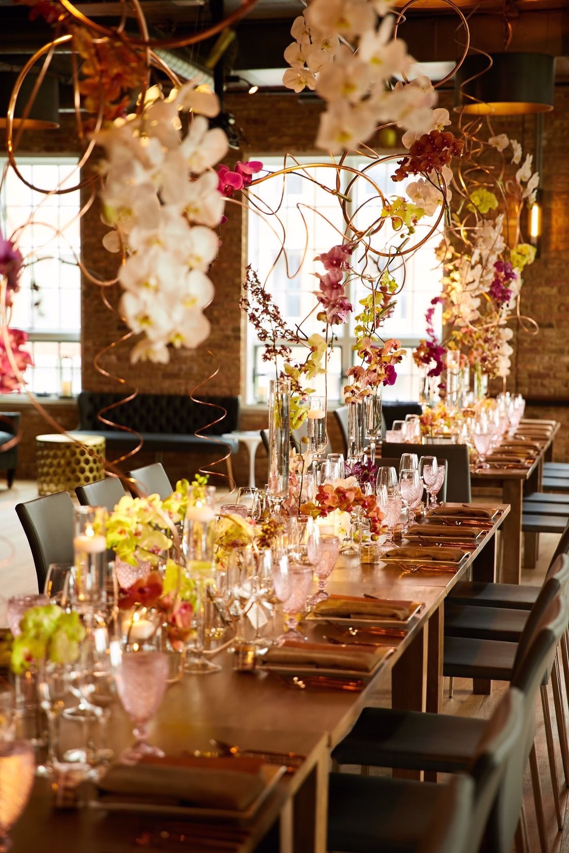 Elegant wedding reception tablescape with dramatic floral centerpieces and warm lighting designed by Chicago wedding and event designer Erin McDonald