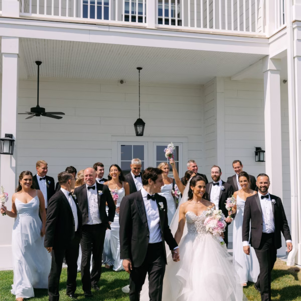 Elegant bridal party celebration coordinated by destination wedding designer Erin McDonald featuring bride and groom with wedding party in formal attire at luxury destination venue