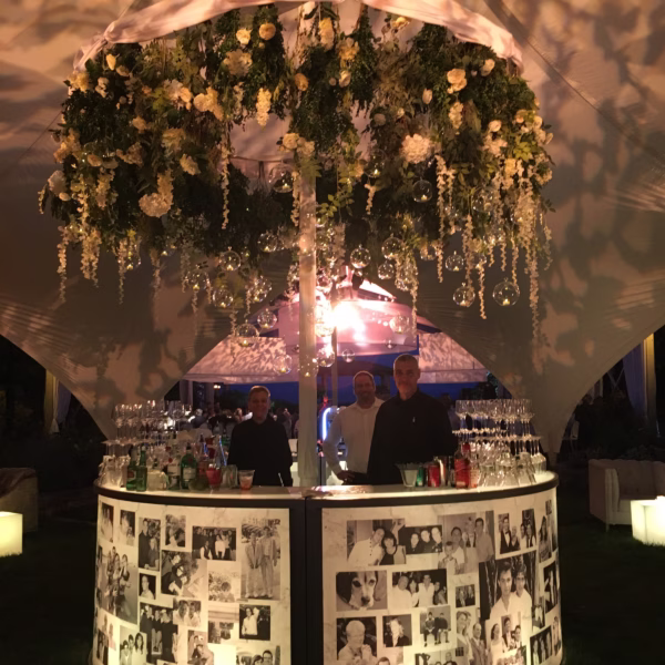 Elegant wedding bar with lush floral canopy and personal photo display designed by Chicago and Rochester NY wedding designer Erin McDonald