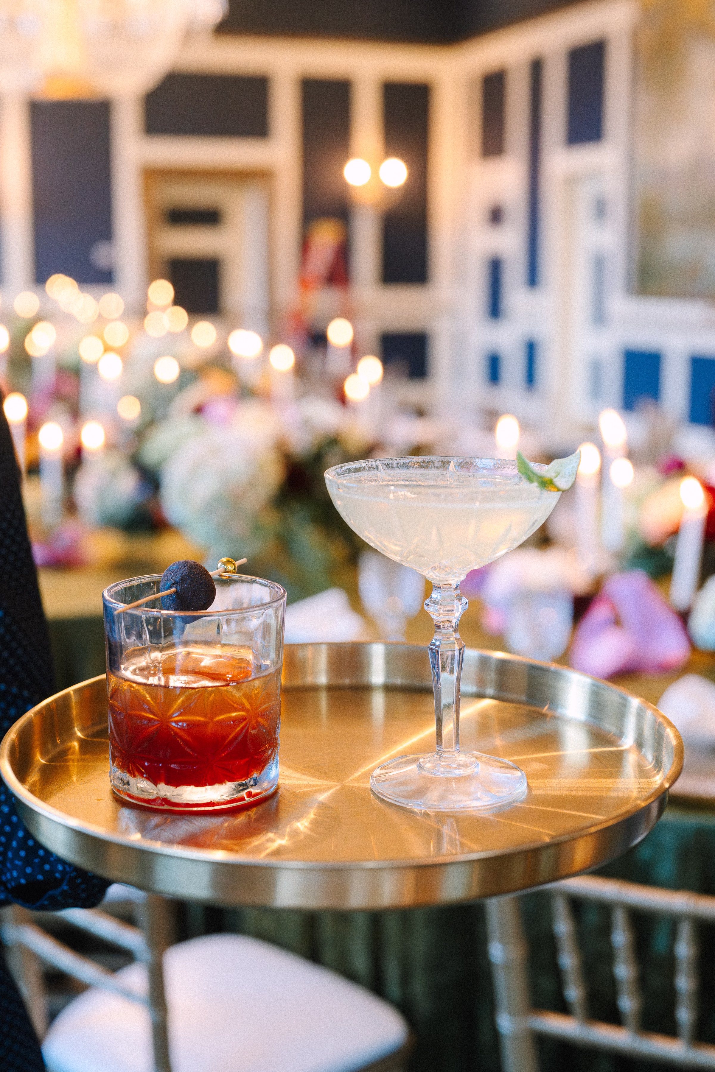Elegant cocktail hour setup with craft cocktails on gold tray